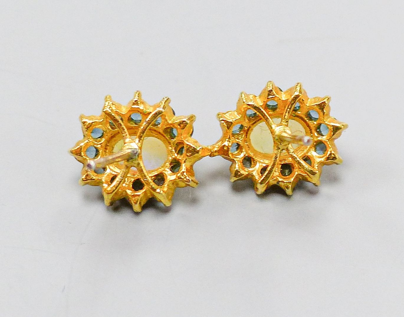 A pair of yellow metal, opal and sapphire oval cluster set ear studs(no butterflies), 10mm, gross 1.4 grams.
